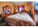 Bedroom with floral bedding and a large mirror at 2648 Roslyn Ave, Charlotte, NC 28208