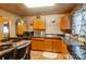 Functional kitchen featuring wood cabinets and an eat-in kitchen area at 2648 Roslyn Ave, Charlotte, NC 28208