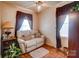 Small living room with a recliner and houseplants at 2648 Roslyn Ave, Charlotte, NC 28208