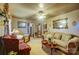 Living room with comfy seating, a ceiling fan, and decorative accents at 2648 Roslyn Ave, Charlotte, NC 28208