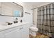 Modern bathroom with white vanity, black fixtures, and geometric shower curtain at 311 Drury Dr, Charlotte, NC 28206