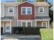 Modern two-story townhome with red accents and well-manicured landscaping at 311 Drury Dr, Charlotte, NC 28206