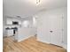 Modern eat-in kitchen with white cabinets and light wood floors at 311 Drury Dr, Charlotte, NC 28206