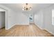 Spacious living room with light wood floors and a modern chandelier at 311 Drury Dr, Charlotte, NC 28206