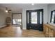 Light and airy entryway with hardwood floors and a black door at 31934 Ameron Cir, Albemarle, NC 28001