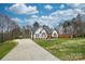 White brick home with brown accents and a long driveway at 31934 Ameron Cir, Albemarle, NC 28001