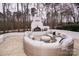 Curved seating area around a firepit on a flagstone patio at 31934 Ameron Cir, Albemarle, NC 28001