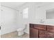 Clean bathroom with dark brown vanity and shower/tub combo at 3220 Capitol Dr, Charlotte, NC 28208