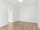 Simple bedroom with light wood flooring and an adjacent door at 3220 Capitol Dr, Charlotte, NC 28208