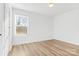 Well-lit bedroom with light wood flooring and window blinds at 3220 Capitol Dr, Charlotte, NC 28208