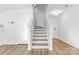 Modern staircase with a stylish wood and white tile design at 3220 Capitol Dr, Charlotte, NC 28208