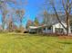 White brick ranch home with mature trees and a large grassy yard at 3720 Fairlane Dr, Gastonia, NC 28056