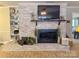 Large whitewashed brick fireplace with a built-in entertainment center at 3720 Fairlane Dr, Gastonia, NC 28056