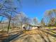 Ranch house with driveway and mature trees in the background at 3720 Fairlane Dr, Gastonia, NC 28056