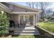 Charming back porch with chairs and a grill, seamlessly blending indoor-outdoor living at 3828 Chandworth Rd, Charlotte, NC 28210