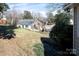 Backyard view of property and home with mature landscaping and exterior brick detail at 3828 Chandworth Rd, Charlotte, NC 28210