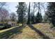 Backyard featuring a shed with double doors and surrounding trees at 3828 Chandworth Rd, Charlotte, NC 28210