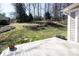 Spacious backyard featuring a wooden deck, greenery, and natural landscape at 3828 Chandworth Rd, Charlotte, NC 28210