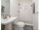 This bathroom boasts a white tile shower with pebble flooring and a sleek pedestal sink at 3828 Chandworth Rd, Charlotte, NC 28210