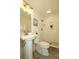 Elegant bathroom featuring a pedestal sink, framed mirror, and a walk-in shower with pebble flooring at 3828 Chandworth Rd, Charlotte, NC 28210