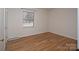 Cozy bedroom featuring hardwood floors and a window with natural light at 3828 Chandworth Rd, Charlotte, NC 28210