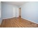 Bedroom with hardwood floors, neutral walls, and an ensuite bathroom at 3828 Chandworth Rd, Charlotte, NC 28210