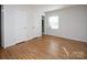 This bedroom features beautiful hardwood floors, a window and two closets for storage at 3828 Chandworth Rd, Charlotte, NC 28210