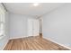 Bright bedroom featuring hardwood floors, a window, and a closet for ample storage space at 3828 Chandworth Rd, Charlotte, NC 28210