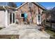 Cozy outdoor deck with seating, an umbrella, and brick exterior at 3828 Chandworth Rd, Charlotte, NC 28210