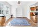 The sunny dining room boasts beautiful floors, a large window, and a white bookshelf at 3828 Chandworth Rd, Charlotte, NC 28210