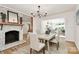 Elegant dining area with a fireplace, a chandelier, and neutral decor throughout the space at 3828 Chandworth Rd, Charlotte, NC 28210