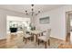 Cozy dining room featuring hardwood floors, modern light fixtures, and comfortable seating at 3828 Chandworth Rd, Charlotte, NC 28210