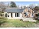 Rear view of the house featuring a deck with seating and a spacious yard at 3828 Chandworth Rd, Charlotte, NC 28210