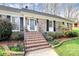 Charming brick home featuring a welcoming front entrance with landscaped garden beds and brick steps at 3828 Chandworth Rd, Charlotte, NC 28210
