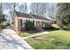 Lovely brick home with walkway, green lawn and professionally landscaped front yard at 3828 Chandworth Rd, Charlotte, NC 28210