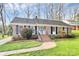 Charming brick home featuring a well-manicured lawn and a welcoming entrance at 3828 Chandworth Rd, Charlotte, NC 28210