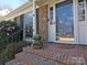 Inviting front porch with brick steps, flower accents, and a stylish glass front door at 3828 Chandworth Rd, Charlotte, NC 28210