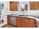 Bright kitchen with stainless steel dishwasher and sink with a view to the backyard at 3828 Chandworth Rd, Charlotte, NC 28210