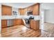 Modern kitchen with hardwood floors, wood cabinets, and stainless steel appliances at 3828 Chandworth Rd, Charlotte, NC 28210