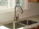 Close-up of the sink area, with a stainless steel faucet, granite countertops, and white subway tile backsplash at 3828 Chandworth Rd, Charlotte, NC 28210