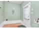 Laundry room featuring tile floors, fresh mint walls, and a bright window at 3828 Chandworth Rd, Charlotte, NC 28210