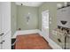 The empty laundry room has a brown-tiled floor, white walls, and a windowed door at 3828 Chandworth Rd, Charlotte, NC 28210