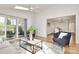Open living room featuring sliding door access to outdoor living space at 3828 Chandworth Rd, Charlotte, NC 28210