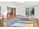 Open-concept living room with hardwood floors, fireplace, and sliding glass doors to the patio at 3828 Chandworth Rd, Charlotte, NC 28210