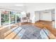 Bright living room featuring hardwood floors, a ceiling fan, and access to the patio at 3828 Chandworth Rd, Charlotte, NC 28210