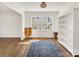 Stylish living room with hardwood floors, white bookshelf, and ample natural light at 3828 Chandworth Rd, Charlotte, NC 28210