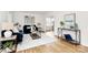 Bright living room featuring hardwood floors, blue sofas, stylish rug and a modern decor at 3828 Chandworth Rd, Charlotte, NC 28210