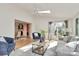 Bright living room with a ceiling fan, modern furniture, and sliding glass doors at 3828 Chandworth Rd, Charlotte, NC 28210