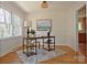 Bright home office with hardwood floors, large windows, and a stylish desk at 3828 Chandworth Rd, Charlotte, NC 28210