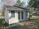 Backyard shed with white trim and double doors providing extra storage space at 3828 Chandworth Rd, Charlotte, NC 28210